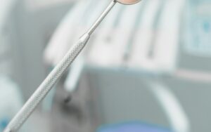 Dental mirror in a clinical office used to examine a tooth for a crown