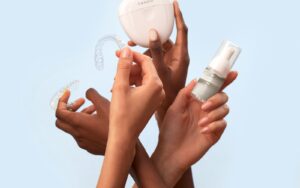 Hands holding clear Invisalign aligners and a storage case