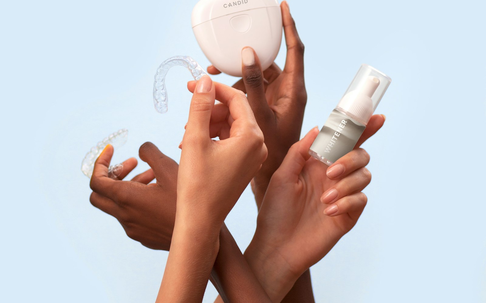 Hands holding clear Invisalign aligners and a storage case
