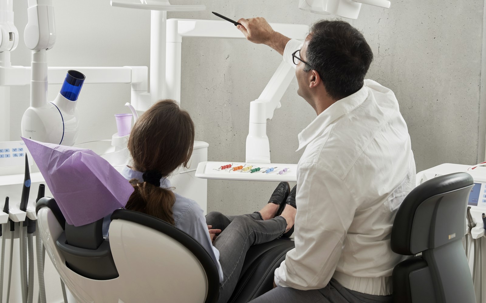 Dental professional reviewing a patient’s treatment plan and insurance benefits